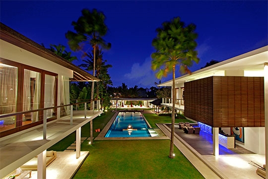 The villa lawns and pool at night
